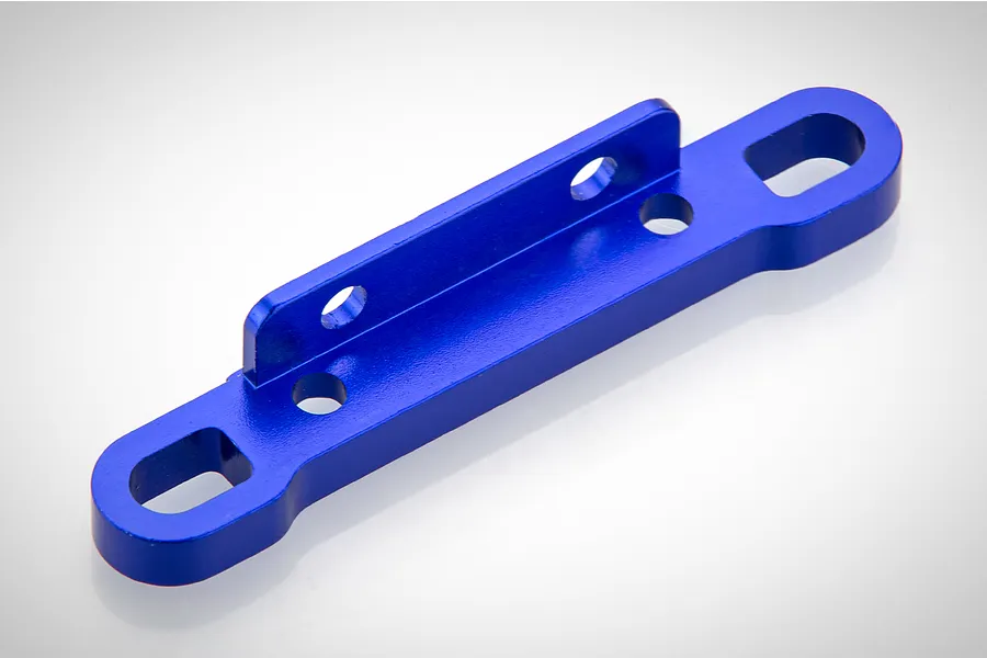 A blue anodized aluminum rear upper suspension arm pin mount for an RC car, shown against a plain white background.