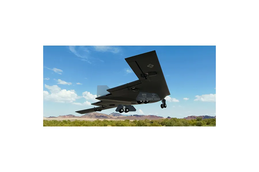 A digital rendering of a B-2 Spirit stealth bomber flying over a desert landscape in the RealFlight simulator.