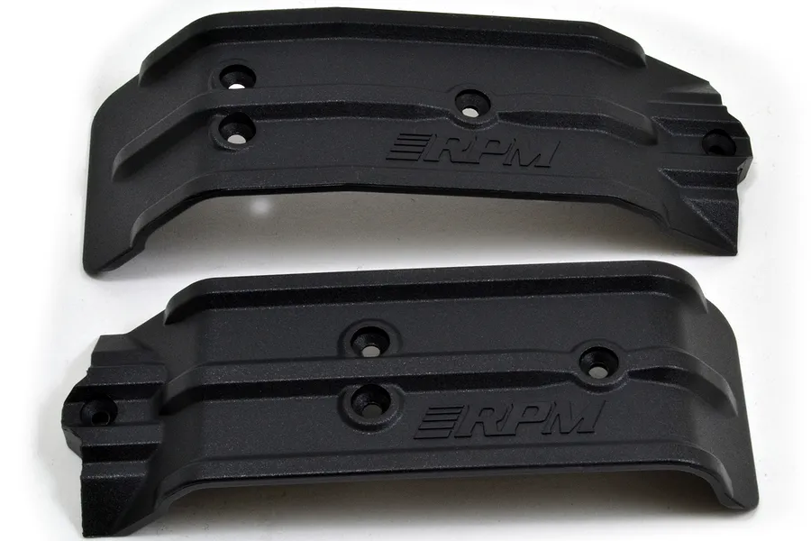 Two black RPM RC skid plates for front and rear chassis protection, featuring molded RPM branding and screw holes on a white background.