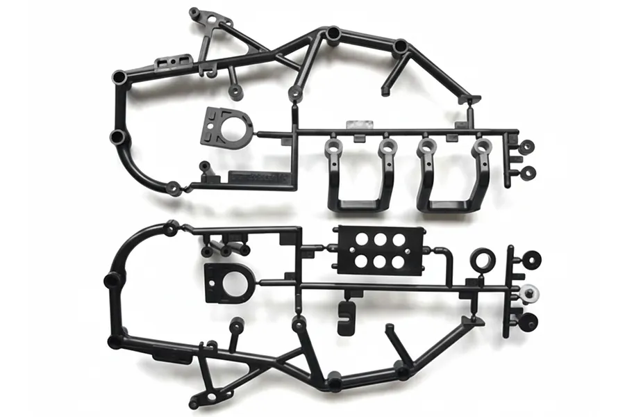 Two black plastic RC car roll cage and mount parts trees on a white background.