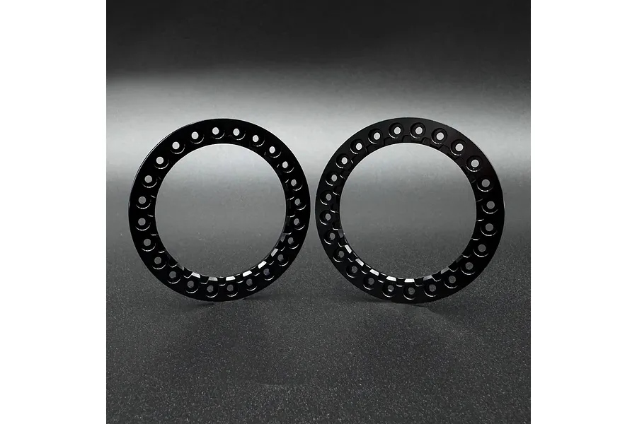 Two black circular aluminium beadlock rings for 1.9 inch RC wheels, displayed side-by-side against a dark grey background.
