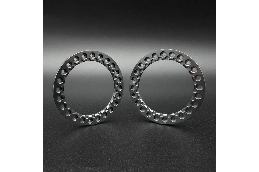 Two grey aluminium 1.9 inch beadlock rings for RC crawler wheels, shown side by side against a dark background.