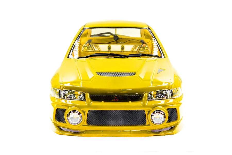 Front view of a yellow 1/10 scale Mitsubishi Lancer Evo IV RC car body shell with detailed headlights, grille, and windshield wipers.