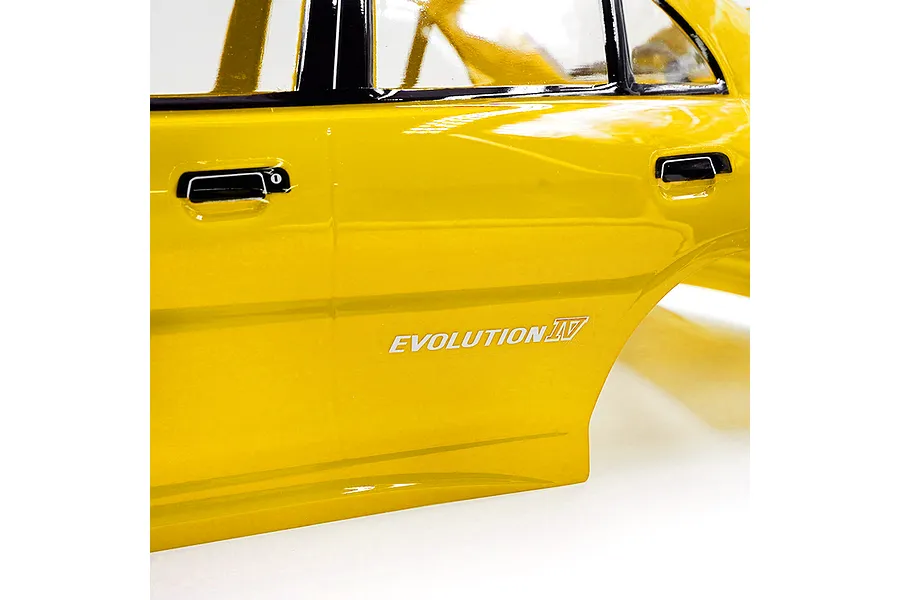 Close-up of a yellow RC Mitsubishi Lancer Evolution IV body shell showing the side profile, door handles, and Evolution IV decal.