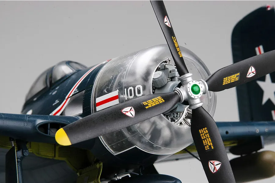 Close-up of a 1/32 scale Trumpeter F8F-1 Bearcat model aircraft, focusing on the propeller, engine cowling, and cockpit area against a plain background.