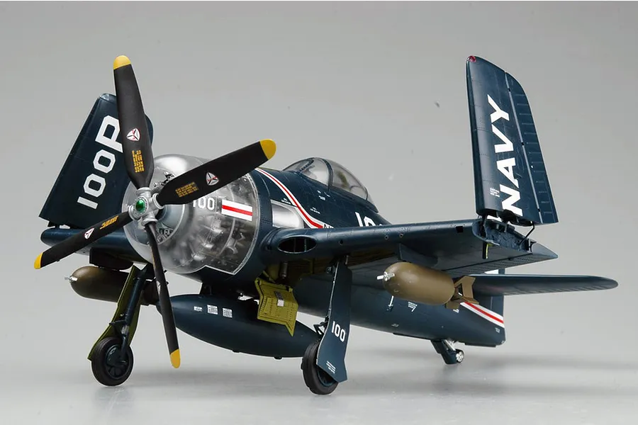 A fully assembled and painted 1/32 scale model of a US Navy F8F-1 Bearcat fighter plane with folded wings, displayed against a plain grey background.