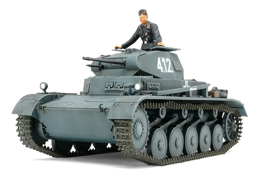 A fully assembled and painted 1/48 scale Tamiya German Panzer II tank model with a crew member figure in the turret hatch.