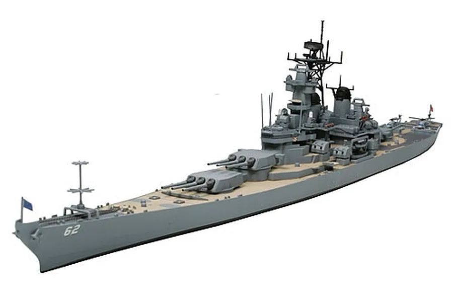 A completed 1/700 scale plastic model of the U.S.S. New Jersey battleship, showing the grey hull, tan deck, and detailed superstructure against a white background.
