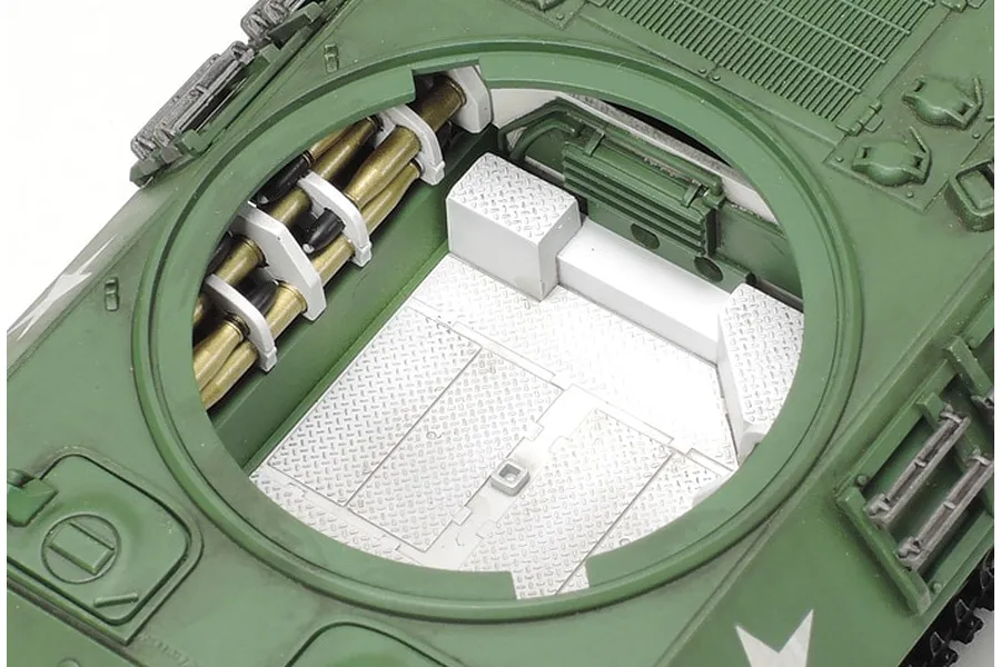Top-down view of a Tamiya 1/48 scale M10 IIC Achilles tank model kit showing the open turret interior with ammunition storage.