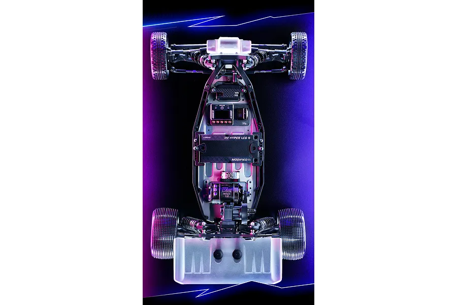 Top-down view of an XRAY XB2'26 1/10 scale 2WD RC buggy chassis, fully assembled with electronics, on a dark background with blue and purple lighting.