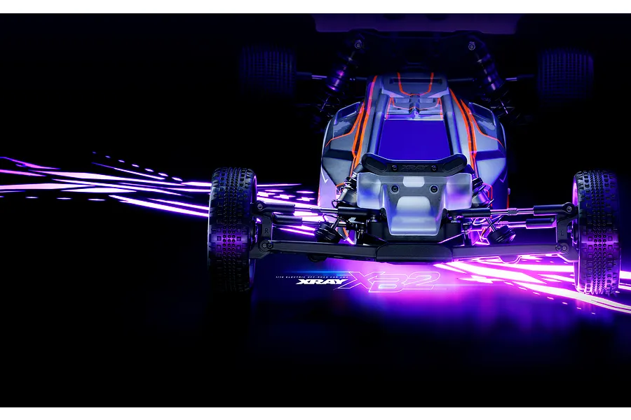 Front view of an XRAY XB2'26 1/10 scale 2WD electric RC buggy on a dark background with purple light streaks.