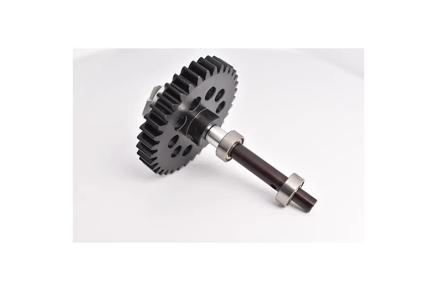 A black metal spur gear attached to a metal shaft with two ball bearings, isolated on a white background.