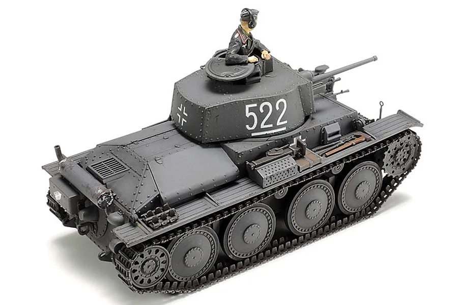 A fully assembled and painted 1/48 scale Tamiya German Panzer 38(t) model tank with a crew figure in the turret, viewed from a high rear angle.