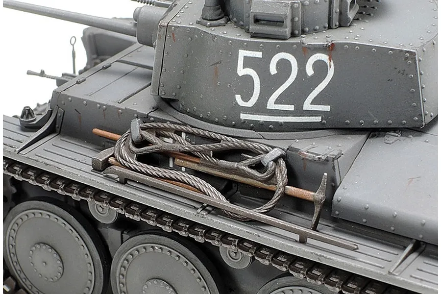 Close-up of a 1/48 scale model Panzer 38(t) tank showing the turret with number 522, tow cable, and tools on the fender.