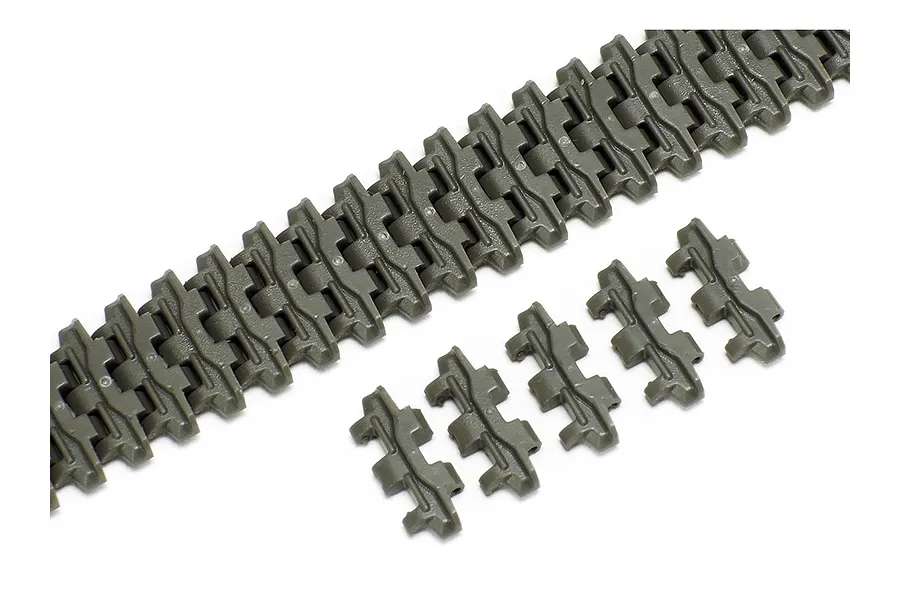 A close-up view of olive-drab plastic tank track links for a Tamiya model kit, showing a long assembled track section and several individual spare links.