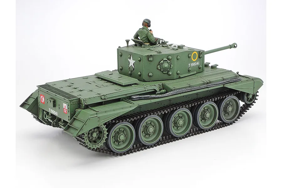 A rear three-quarter view of a Tamiya 1/35 scale British Cromwell Mk.IV tank model, painted in olive green with a tank commander figure in the turret.