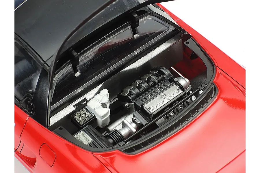 Close-up of the detailed engine bay of a 1/24 scale Tamiya Honda NSX model car, showing the DOHC VTEC engine and open rear hatch.