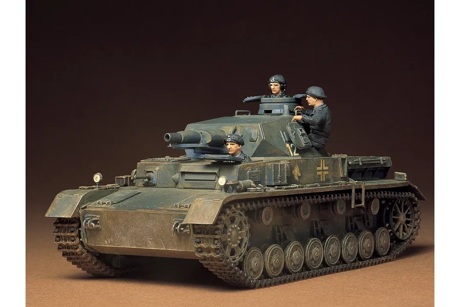 A completed 1/35 scale Tamiya Panzer IV Ausf.D model tank with painted crew figures, displayed against a plain brown background.