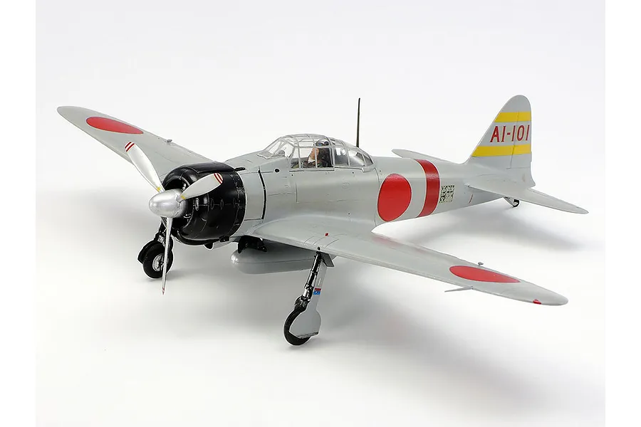 A fully assembled and painted 1/48 scale model of a Mitsubishi A6M2 Zero fighter plane, featuring grey fuselage, red roundels, and black engine cowling.