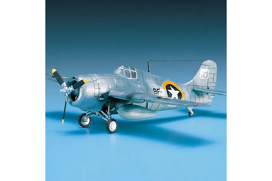 A completed 1/72 scale plastic model of a silver F4F-4 Grumman Wildcat fighter plane, displayed on a blue background.