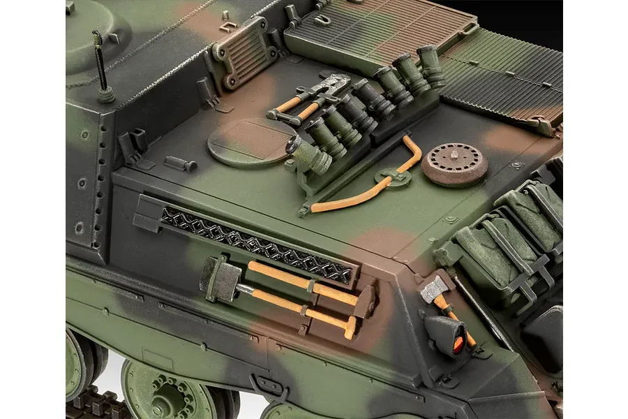 Close-up of a painted 1/35 scale model tank showing detailed exterior tools, hatches, and camouflage paint scheme.