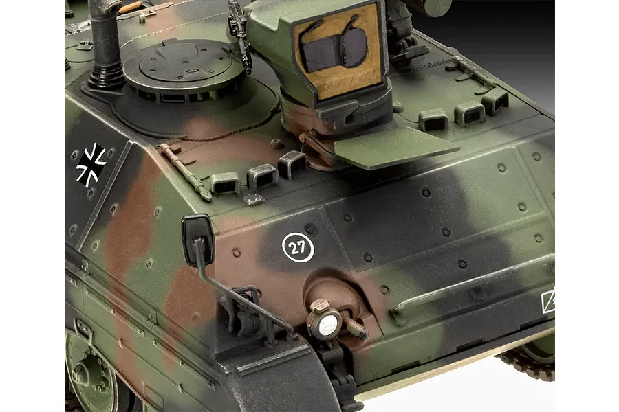 Close-up of a 1/35 scale model Raketenjagdpanzer Jaguar 1 tank, showing the camouflaged hull, turret, and German military markings.