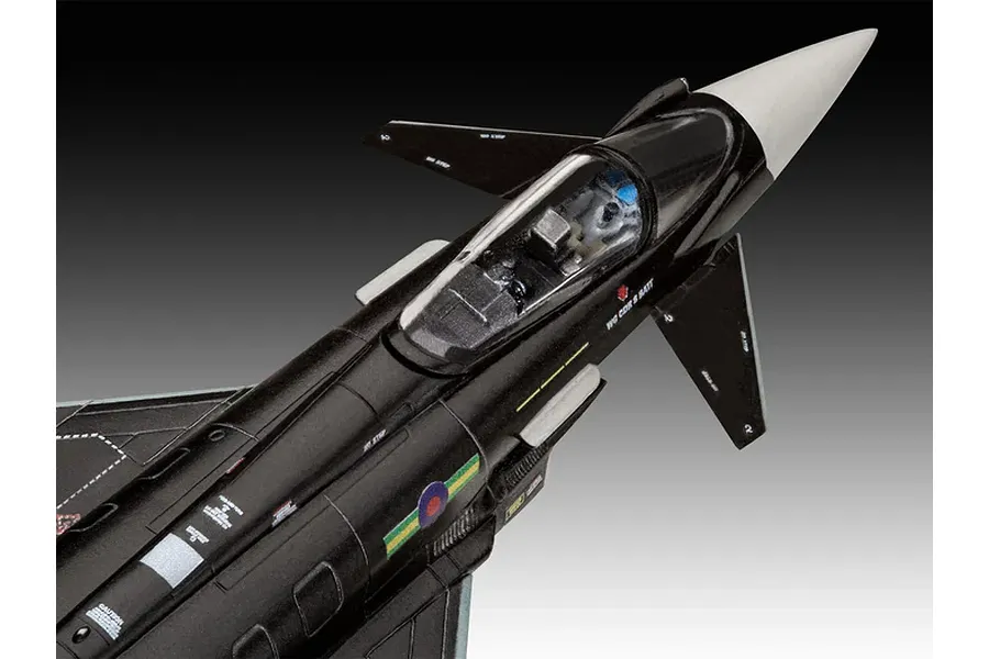 A close-up, high-angle view of a 1/144 scale plastic model of a black Eurofighter Typhoon fighter jet, showing the cockpit and fuselage details.