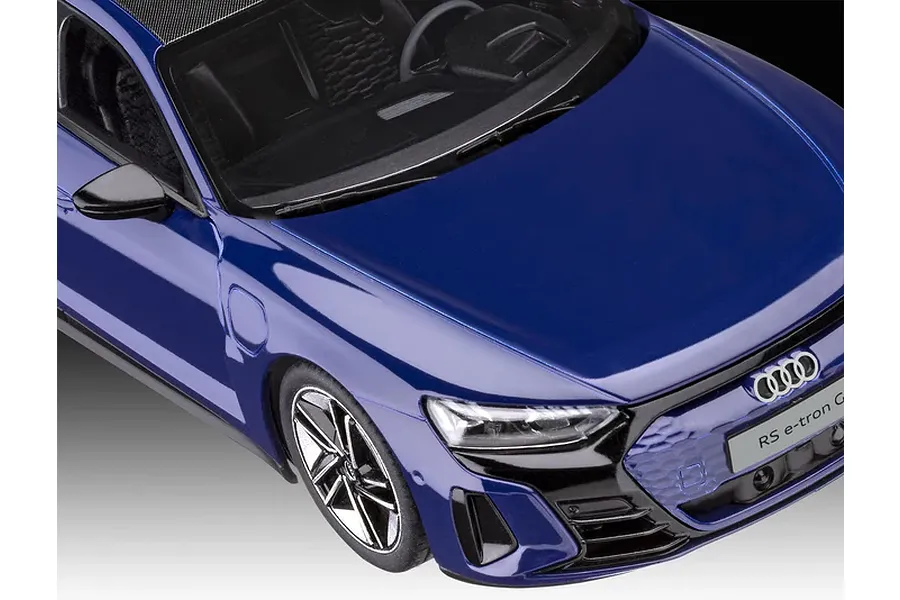 A close-up, high-angle view of a blue Revell 1/24 scale Audi E-Tron GT plastic model car showing the hood, front grille, and driver-side interior.