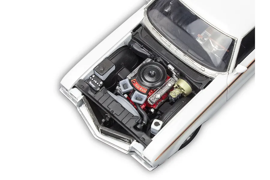 High-angle view of a white 1970 Buick GSX model car with the hood open, revealing a detailed red engine bay.