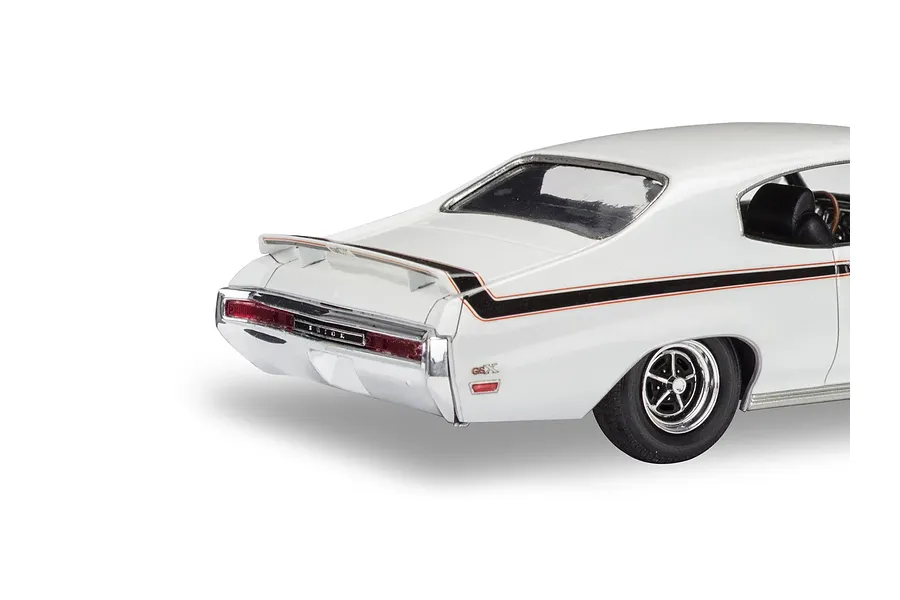Rear three-quarter view of a white 1970 Buick GSX scale model car with black and orange racing stripes.