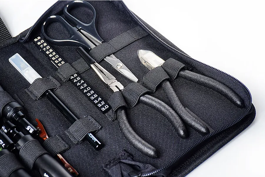 Close-up of a black Koswork foldable tool bag filled with various RC hobby tools including pliers, scissors, and drivers.