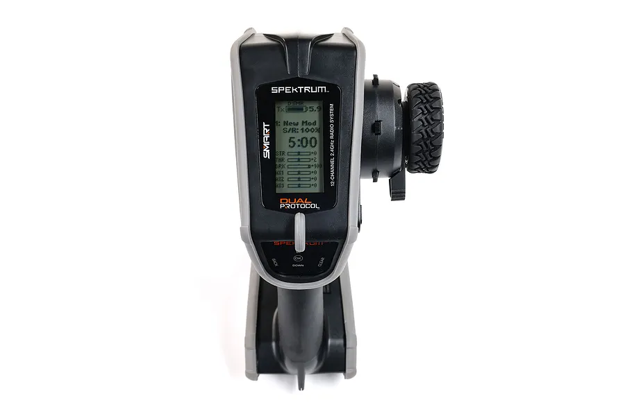Front view of a Spektrum DX Rugged radio transmitter with a black and grey housing and a steering wheel on the right side.