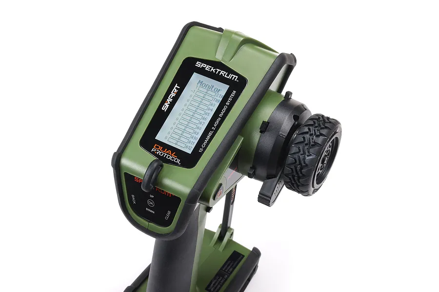 Spektrum DX Rugged DSMR+ 12-channel RC transmitter in green, featuring a ruggedized design, steering wheel, and digital display screen.