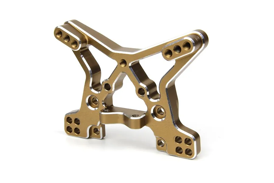 A gold-anodized aluminium front shock tower for an RC car, featuring multiple mounting holes and machined silver edges.