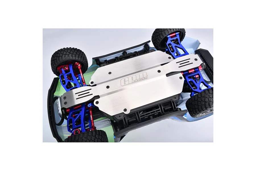 A bottom-up view of an RC car chassis showing a silver GPM Racing stainless steel skid plate installed.