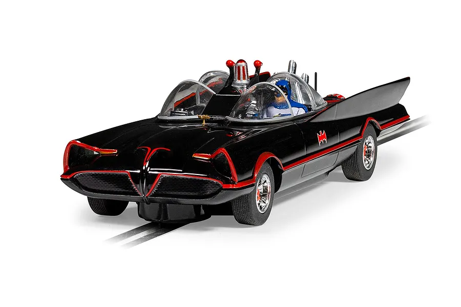 A 1/32 scale Scalextric Batmobile slot car in black with red trim, featuring a Batman figure in the cockpit, positioned on a slot car track.