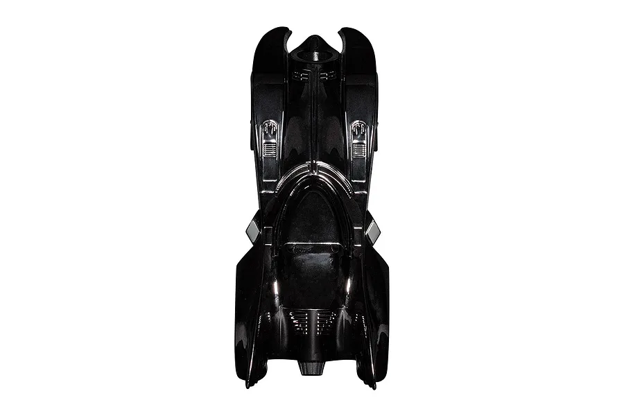 Top-down view of a shiny black chrome Batmobile slot car on a white background.