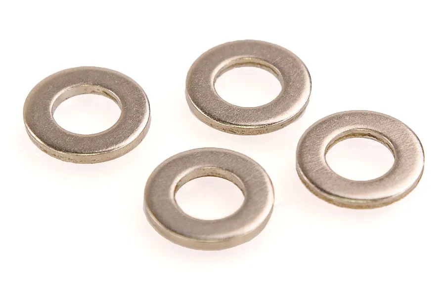 Four small, circular, silver-coloured metal washers arranged on a plain white background.