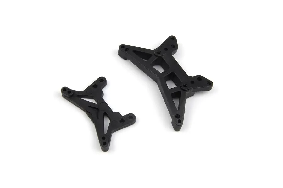 Two black plastic RC shock towers of different sizes on a white background.