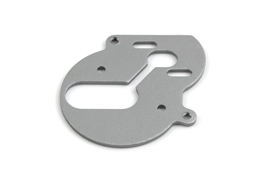 A flat, grey aluminium motor plate for an RC car with various mounting holes and slots, shown on a white background.