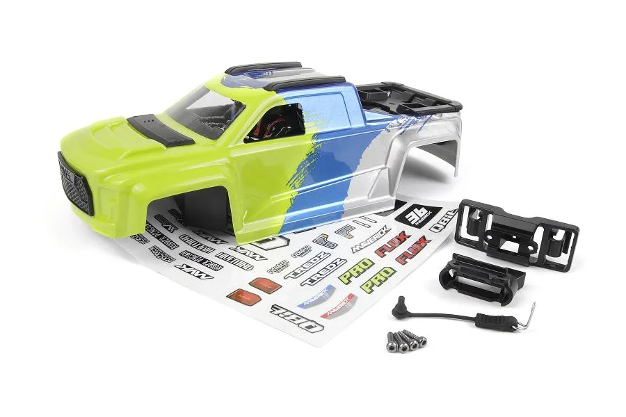 A fluoro green, blue, and silver painted RC truck body shell with a decal sheet and small black plastic accessories on a white background.