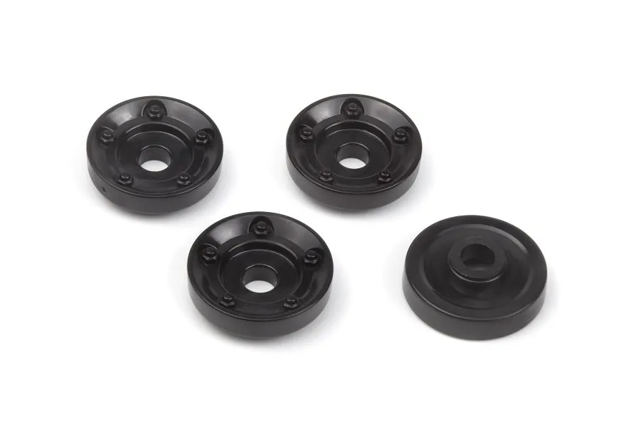 Four black plastic RC wheel washers arranged on a white background.
