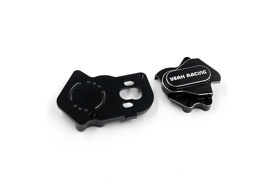 Two black anodized aluminium gearbox housing components for an RC car, featuring the Yeah Racing logo, isolated on a white background.