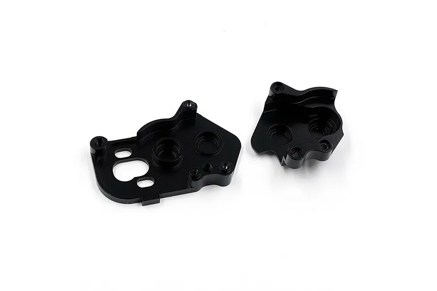 Two black anodized aluminium gearbox housing halves for an RC car, shown from an internal perspective against a white background.