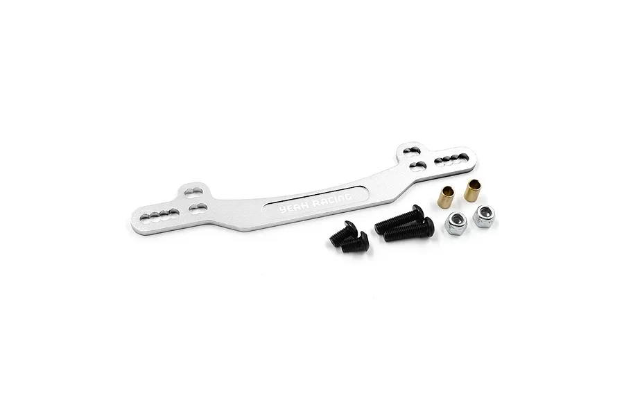 A silver aluminium Yeah Racing rear shock tower for RC cars, accompanied by mounting screws, nuts, and brass spacers on a white background.