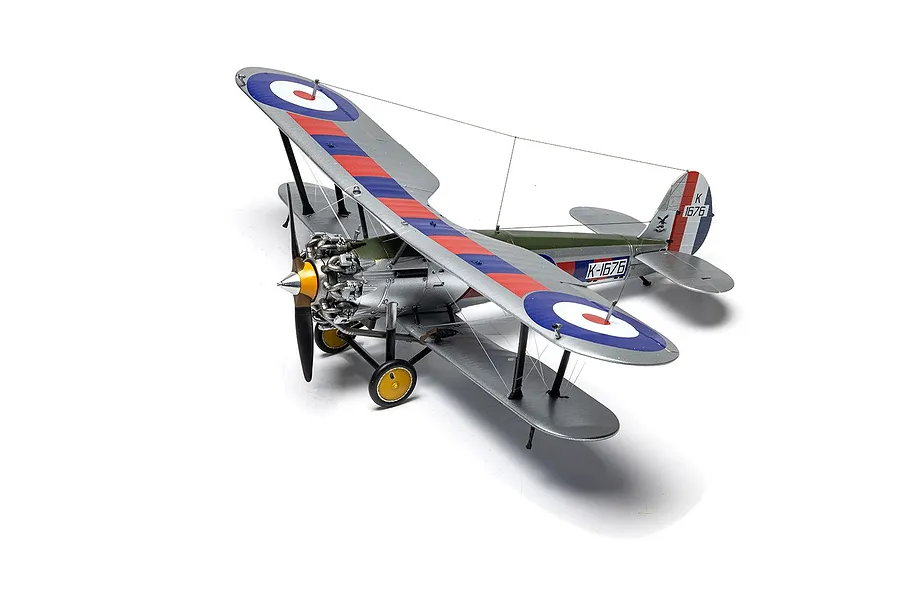 A fully assembled and painted 1/48 scale model of a Bristol Bulldog Mk.IIA biplane fighter, featuring silver, green, and red-blue-white markings.
