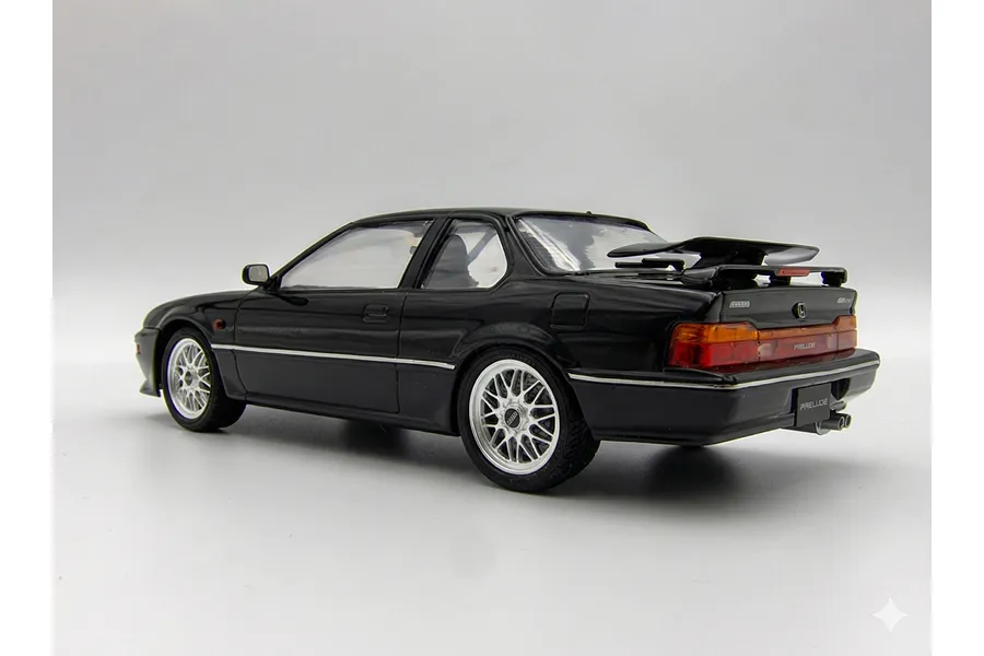 A 1/24 scale model of a black Honda Prelude 2.0Si, viewed from the rear three-quarter angle against a plain white background.