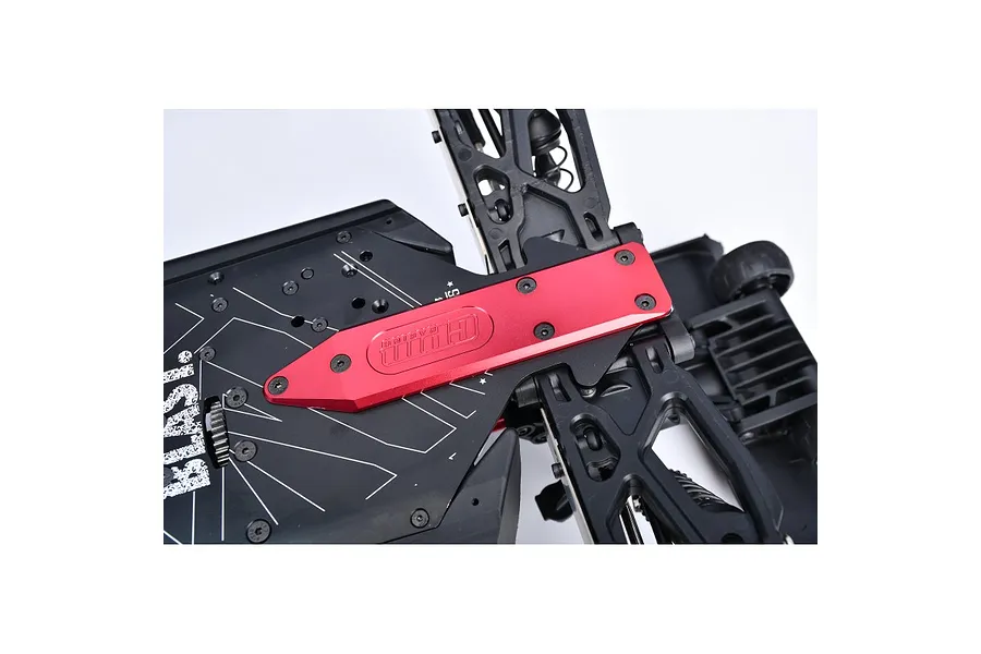 A red GPM Racing aluminium rear skid plate installed on the black chassis of an RC vehicle.