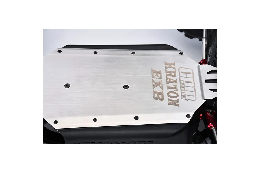 GPM Racing stainless steel chassis skid plate installed on an RC vehicle, featuring engraved GPM, Kraton, and EXB branding.