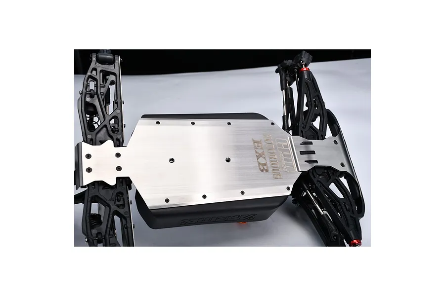 GPM Racing stainless steel chassis skid plate installed on an Arrma Notorious EXB RC vehicle chassis, showing the underside with branding.